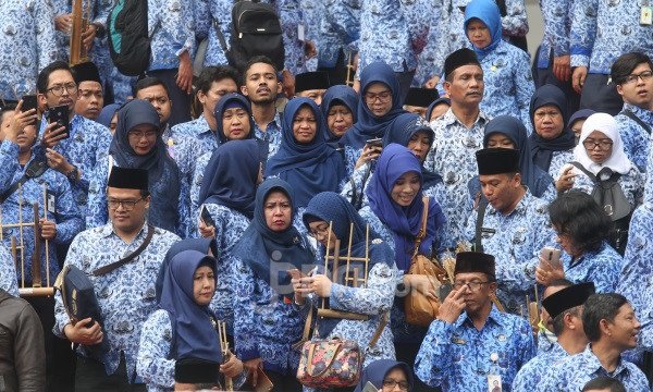 Large group of civil servants in blue uniforms at an outdoor event.